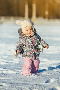 little girl walks in the snow