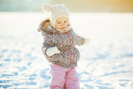 little girl walks in the snow