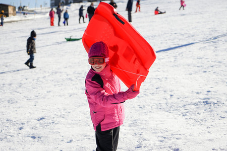 Little girl sledding at Sierra Nevada ski resort