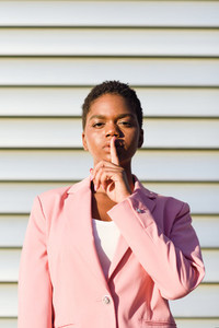 African American business woman doing silence gesture