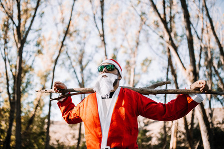Santa claus with sunglasses observe the forest