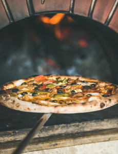 Freshly baked pizza with vegetables in wood oven