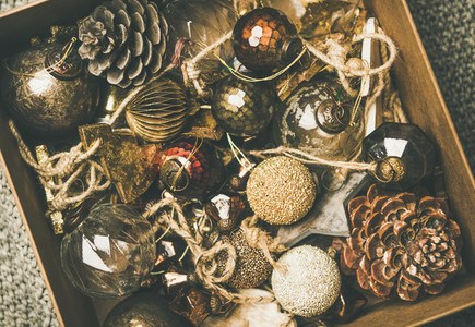 Christmas tree decoration toys and pine cones in box  close up