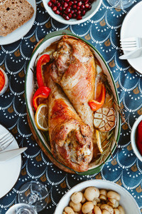 Festive dish for Thanksgiving roasted turkey legs with vegetables on a table with snacks Top view flat lay