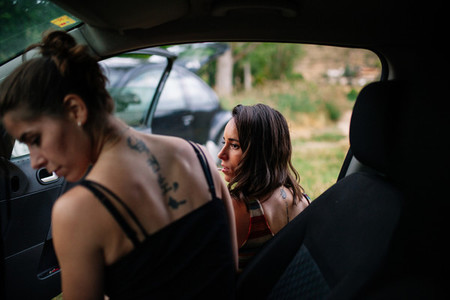 Two young lesbians enjoying inside a car