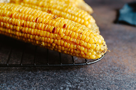 Roasted or grill corn cob with olive oil and salt on a rack Tasty simple recipe top view