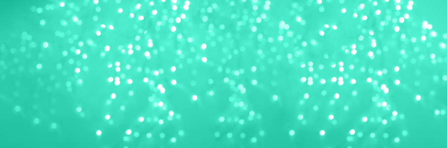 Festive glittering christmas lights  Abstract cement concrete background in trendy mint green and turquoise color  Blurred banner with bokeh