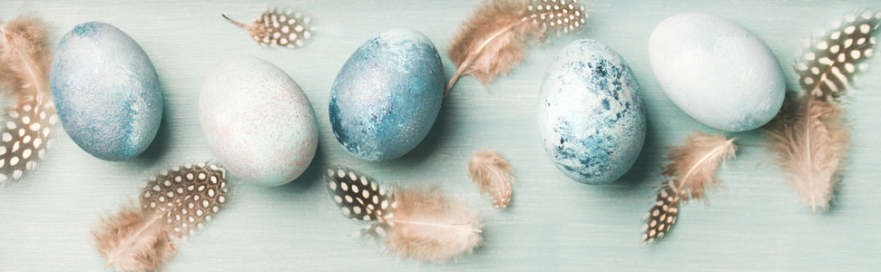Painted eggs for Easter holiday over light blue background