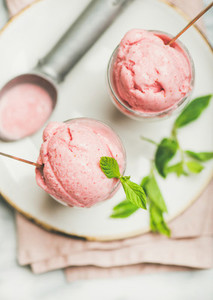 Homemade strawberry yogurt ice cream with mint on plate  close up