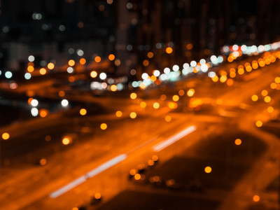 Blurred lights of night city and motion traffic on a highway