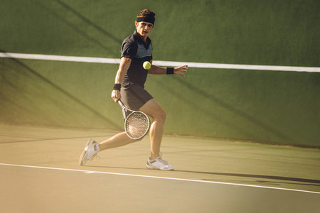 Professional tennis player hitting a strong backhand