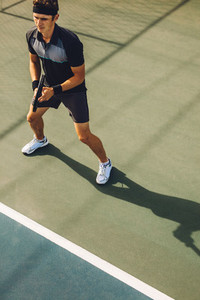 Tennis player ready on the baseline
