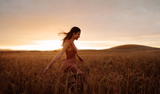 Carefree female strolling in the wheat field