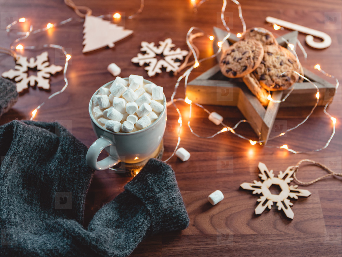 Cozy Christmas or New Year  flat lay  Hot chocolate with marshmallow in a white ceramic mug among winter decor and lights