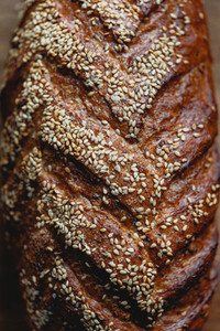 Close up view of whole grain loaf bread crust with sesame