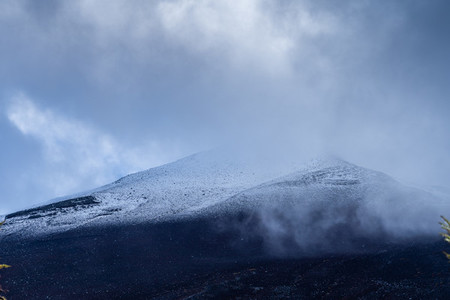 Close up top of Fuji mountain with snow cover and wind on the to