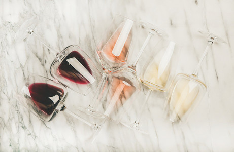 Flat lay of red rose and white wine in glasses