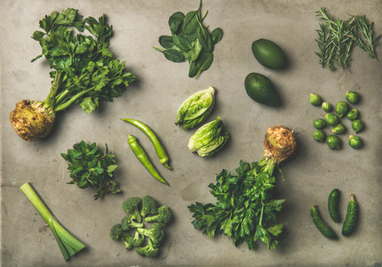 Healthy vegan salad ingredients layout over concrete background