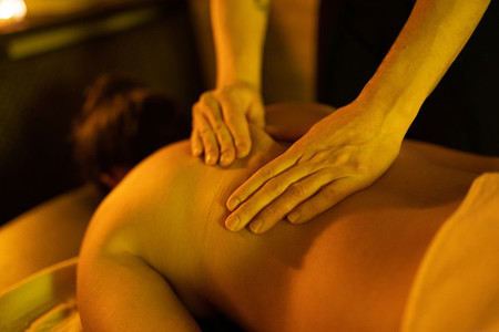 Woman receiving back massage in Arab Baths