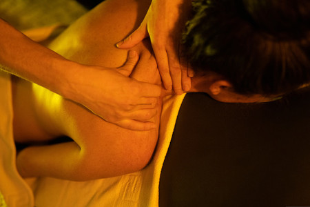 Woman receiving back massage in Arab Baths