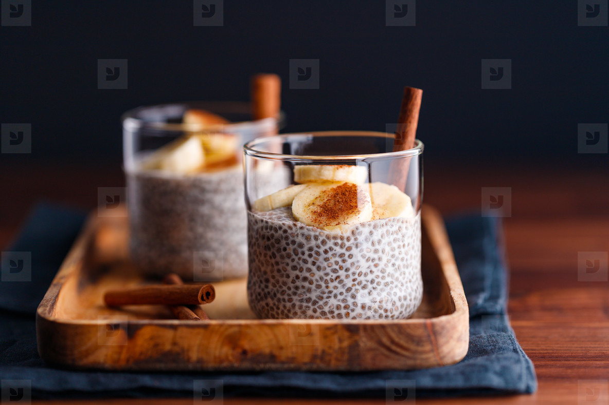 Chia pudding with coconut milk and banana in glasses on a table  Vegetarian healthy dessert