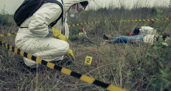 Woman with protection equipment examining evidence