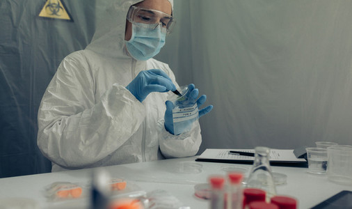 Scientist analyzing samples contaminated with virus