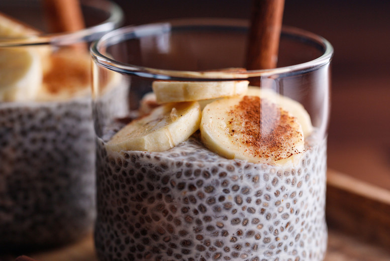 Chia pudding with coconut milk and banana in glasses on a table. Vegetarian healthy dessert.
