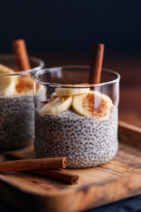 Chia pudding with coconut milk and banana in glasses on a table  Vegetarian healthy dessert