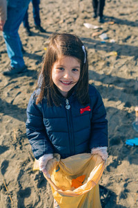 Girl showing garbage collected from the beach
