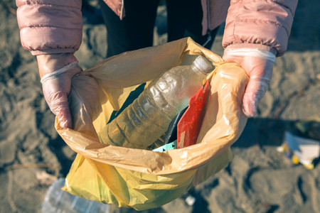 Woman showing garbage collected from the beach