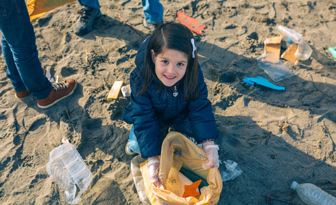 Girl showing garbage collected from the beach