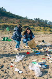 Female volunteers cleaning the beach