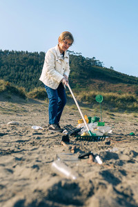 Female volunteer cleaning the beach