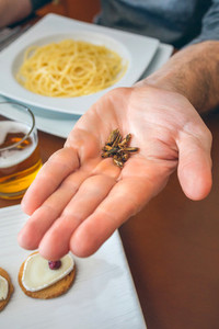 Man showing a handful of crickets