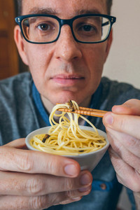 Man eating spaghetti and crickets