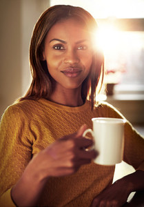 Attractive young woman enjoying a cup of coffee