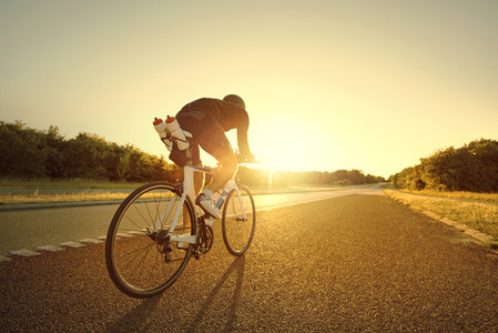 Man taking a bike ride in sunset
