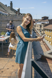 Young woman with mobile on the terrace