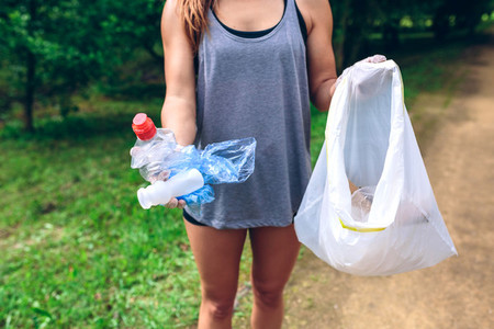Unrecognizable girl showing garbage