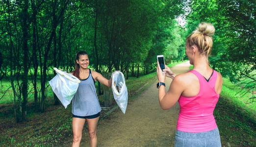 Girl taking picture of a friend after plogging