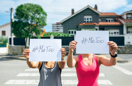 Women showing poster with metoo hashtag