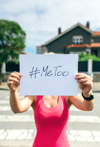 Woman showing poster with metoo hashtag