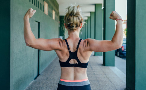 Sportswoman on her back showing muscles