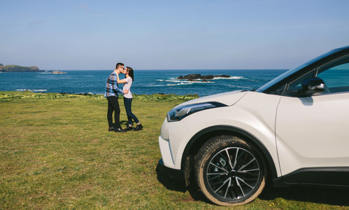 Couple with car watching landscape