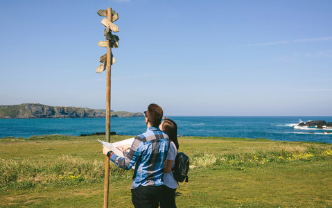 Couple looking a map and direction sign