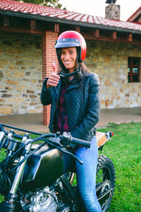 Woman with helmet riding custom motorbike