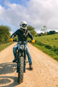 Man with helmet riding custom motorbike