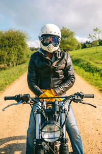 Man with helmet riding custom motorbike