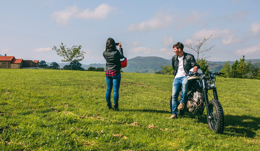 Couple making a landscape photo during a motorcycle trip